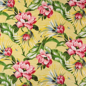 May include: A fabric pattern featuring large pink flowers with dark centers, interspersed with green tropical leaves and spiky yellow and blue foliage, all set against a solid, textured light yellow background in a repeating botanical design.