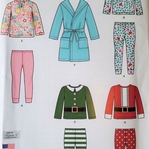 May include: A sewing pattern for children's clothing, featuring a variety of designs including a hooded sweatshirt, a robe, pajamas, and a Christmas-themed outfit. The pattern is for sizes 1/2-4.