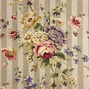 May include: Floral fabric with a striped background. The design features a bouquet of flowers in shades of pink, yellow, purple, and white, with green leaves. The background has vertical beige stripes.