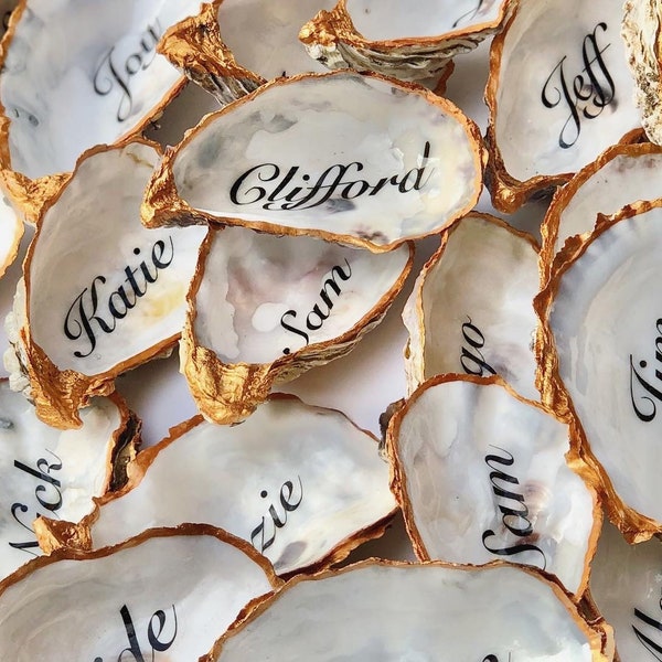 Personalised name Oyster Shell sealed with gloss varnish and gold edging.