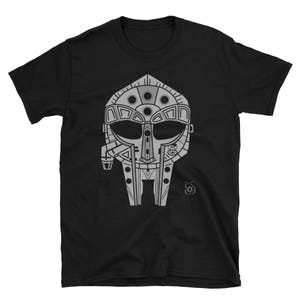 May include: Black t-shirt with a silver graphic of a stylized mask with a futuristic design.