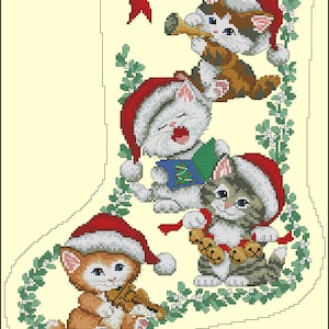 May include: A Christmas stocking with a red bow and holly, decorated with four cats wearing Santa hats. The cats are playing musical instruments, including a violin, a trumpet, a book, and bells. The stocking is surrounded by green holly leaves.