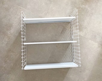 Tomado wall shelves designed by D. Dekker for TOMADO