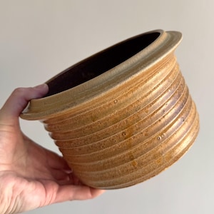 May include: A set of three ceramic mugs with a speckled, matte finish. Each mug features a different color: light blue, cream, and gray. The mugs have a simple, modern design and a comfortable handle.