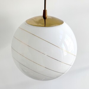 Vintage milk glass globe hanging lamp with golden stripes
