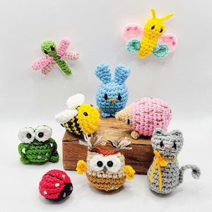 May include: A collection of handmade crochet animal figures, including a dragonfly, butterfly, bunny, hedgehog, bee, frog, ladybug, owl, and cat. Each figure is brightly colored and detailed, showcasing various textures and shapes.