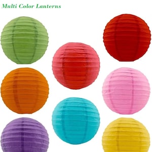 May include: A collection of colorful paper lanterns in various hues, including green, orange, red, blue, pink, purple, and yellow. The lanterns are round and have a ribbed texture. The text "Multi Color Lanterns" is at the top.