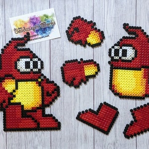 May include: A set of red and yellow pixel art characters made with perler beads. The characters are a robot and a worm. The set includes extra pieces in the shape of hearts.