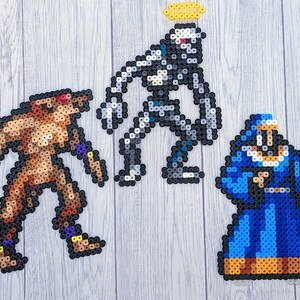 May include: Three pixel art figures made of colourful beads. A brown werewolf-like figure stands on the left, a grey robot-like figure with a halo stands in the centre, and a blue robed figure stands on the right.