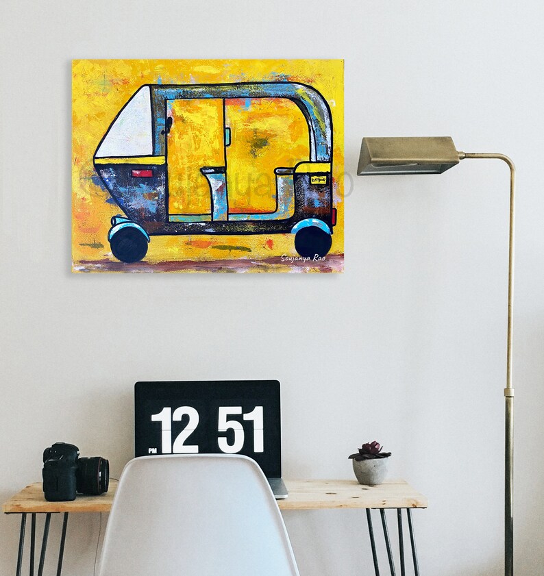 May include: An abstract painting of a yellow and blue auto-rickshaw. The artwork features a yellow background with brushstrokes, and the vehicle is depicted in shades of blue, black, and yellow. The painting is signed by the artist.