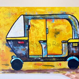 May include: Abstract painting of a yellow, black, and blue auto-rickshaw. The artwork features a textured background and bold outlines, with the artist's signature in the lower right corner. The vehicle has a white roof and blue accents.