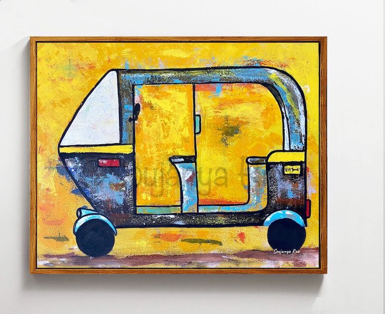 May include: Abstract painting of a black, blue, and yellow auto rickshaw with a white roof. The artwork is set against a textured yellow background and framed in a brown wooden frame. The artist's signature is visible.