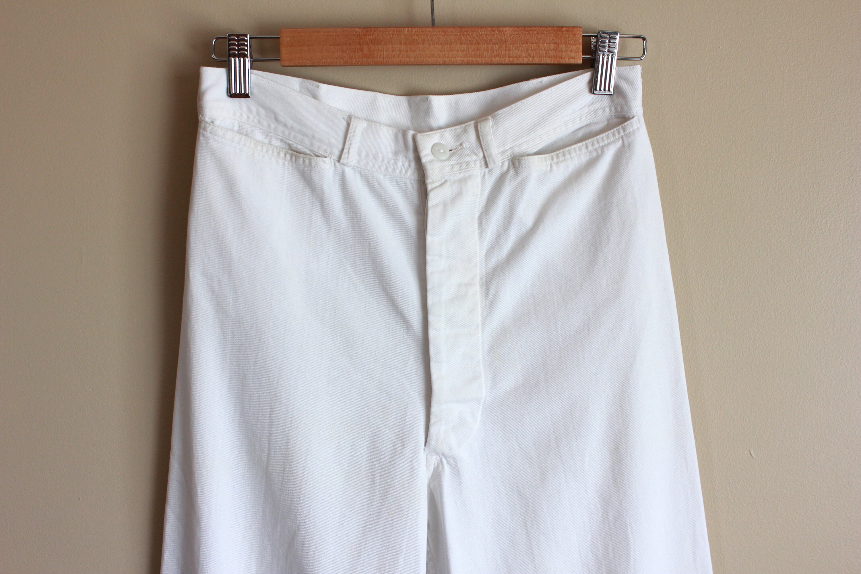 white sailor pants with gold buttons