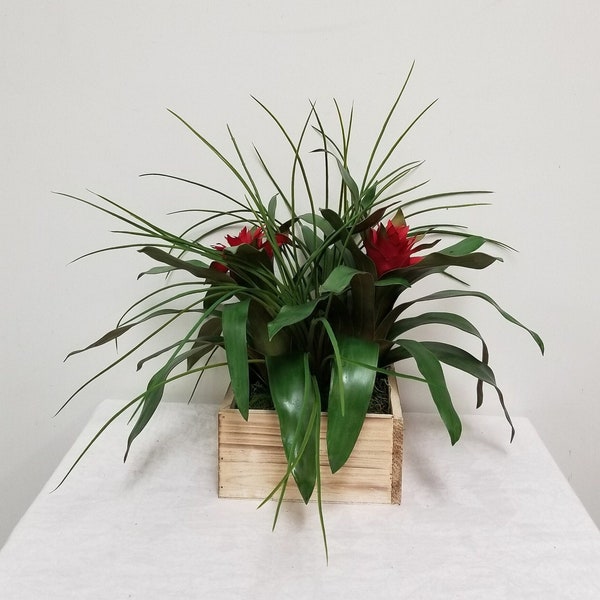 Faux Red Bromeliads, Onion grass potted a square white wooden pot.