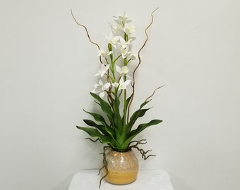 Faux white dendrobium orchid plant, potted in a handcrafted yellow glazed pot, with sheet moss and faux curly willow.