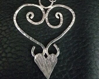 Heart shaped handcrafted artisan made pendent, in Sterling silver, with a hammered textured wire.