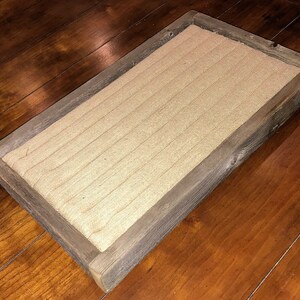 May include: A rectangular wooden tray with a burlap lining. The tray has a rustic, weathered look and is perfect for displaying small items.