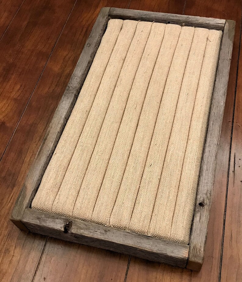 May include: A rustic wooden frame with a burlap fabric insert. The frame has a distressed gray finish and is perfect for displaying small items.