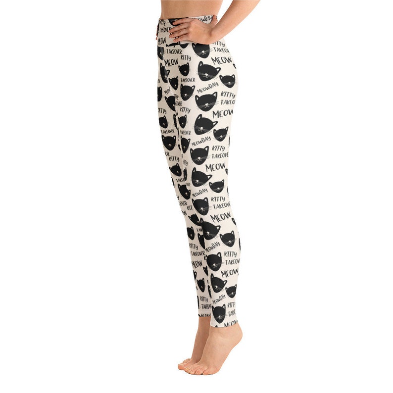 May include: Black and white leggings with a repeating pattern of black cat faces and the text "Kitty Takeover Meow".