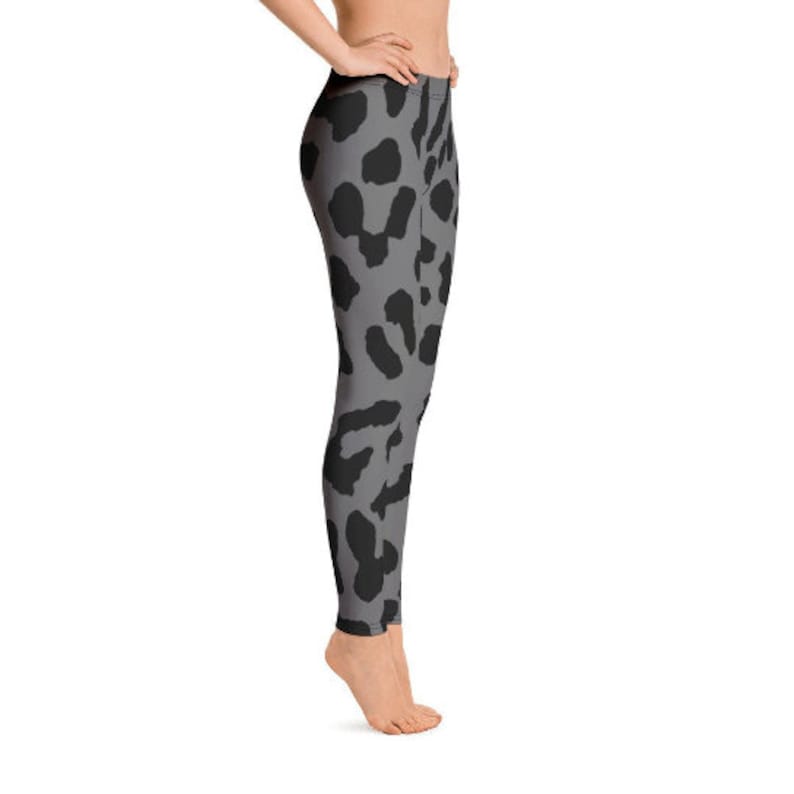 May include: Gray leggings with a black leopard print pattern. The leggings are form-fitting and reach the ankles. The design features irregular black spots on a gray background, creating a stylish animal print.
