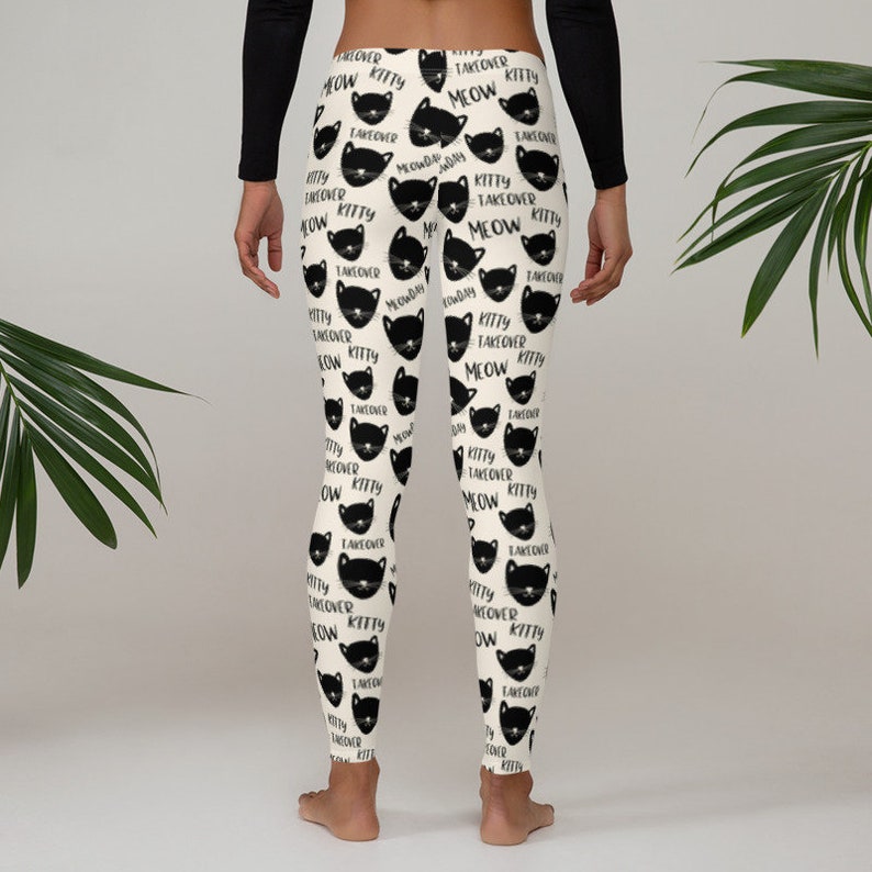 May include: Black and white leggings with a repeating pattern of black cats and the text "Kitty Takeover Meow".