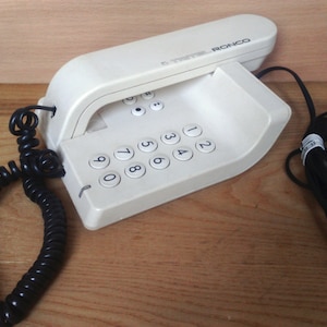 Vintage landline phone. Gray landline phone. Vintage phone. Old landline phone. Old telephone from USSR. Button phone. Home phone wall phone