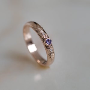 rose gold wedding ring for women with small lab created alexandrite in the middle and golden textured branch as a tiny detail of design