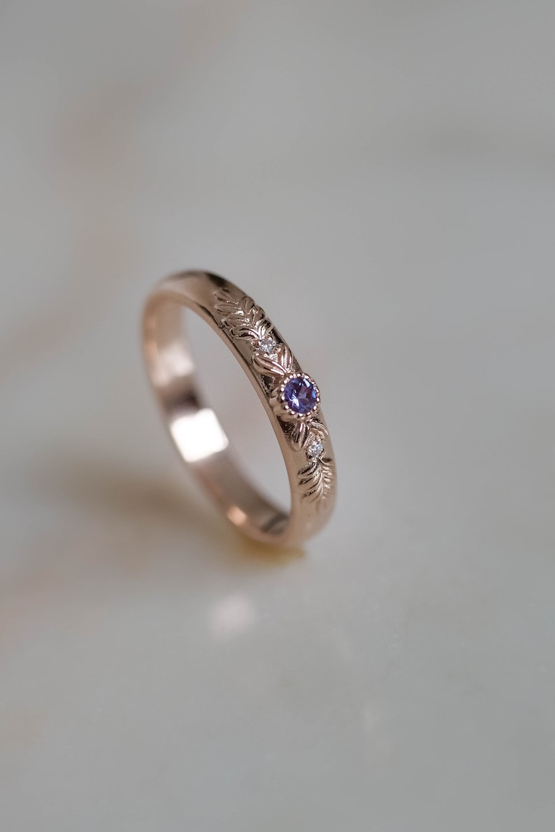 rose gold wedding ring for women with small lab created alexandrite in the middle and golden textured branch as a tiny detail of design