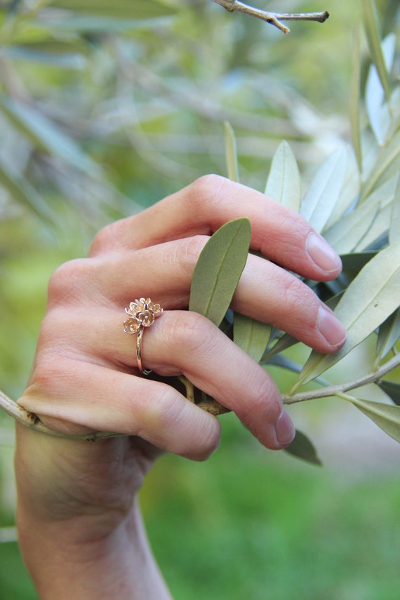 Gold flower engagement best sale ring