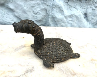 antique turtle, dinosaur or mythical creature from Africa - bronze filled with clay