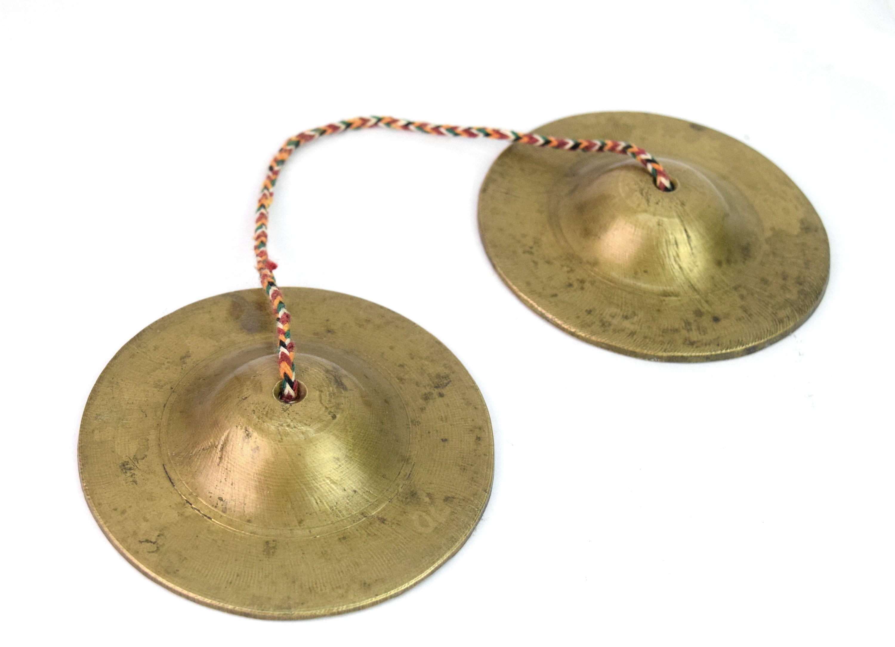 Tingsha Cymbals Tibetan Buddhist Lucky Symbol Embossed Meditation Yoga Bell  Chimes on black contrasting background. Tibetan bells for singing mantra.  Mantra bowls with leather ribbon. Stock Photo