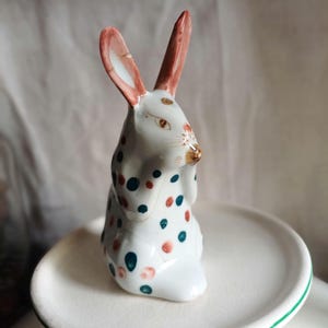 Antique porcelain white rabbit figurine with hand painted brown and green folklore flowers and dots/Vintage ethereal delicate eating bunny