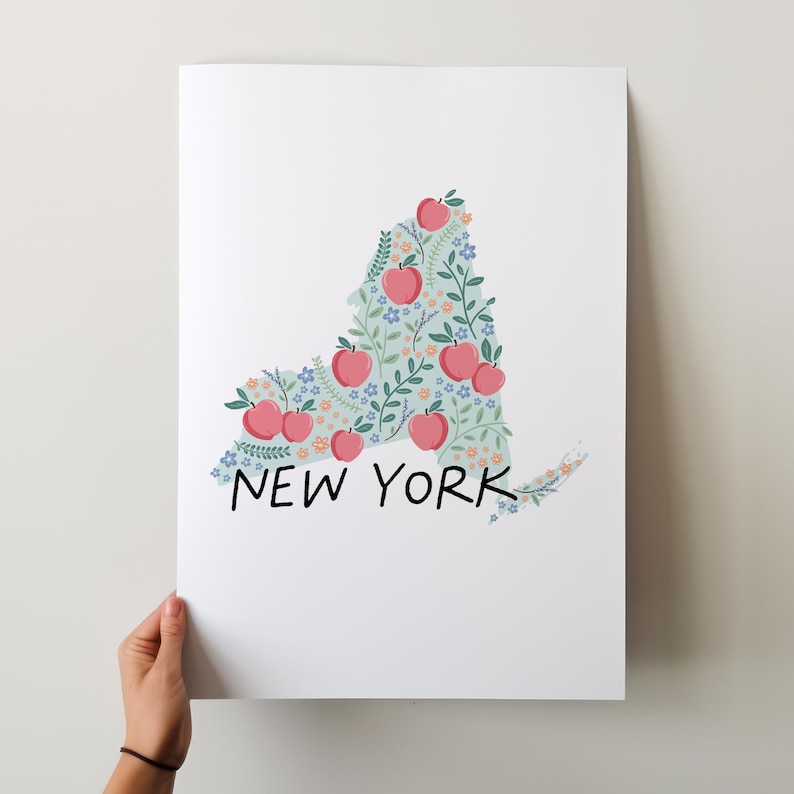 May include: A white background with a light blue outline of the state of New York filled with pink apples and small flowers. The text "NEW YORK" is written in black below the outline.