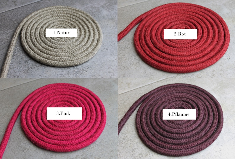 May include: Four coils of braided rope in different colours, each with a white label. The colours are beige labelled 1.Natur, red labelled 2.Rot, pink labelled 3.Pink, and dark plum labelled 4.Pflaume. Each rope is arranged in a tight, circular spiral pattern.