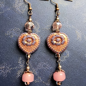 Dangle and drop earrings with pink glass hearts and complementary beads, and antique copper finish accents