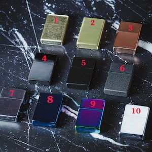 May include: Ten different lighters in various colors and finishes, numbered 1 through 10. The lighters are arranged in two rows of five.