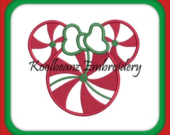 May include: A Christmas-themed design featuring a Mickey Mouse-inspired shape made of red and white striped candy. The design includes a green bow and green accents. The text "Koolbeanz Embroidery" is written in black.