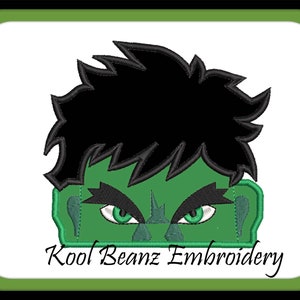 May include: Green and black embroidered design of the Hulk's face with a serious expression. The design includes his green skin, black hair, and angry eyes. "Kool Beanz Embroidery" is written below the design.