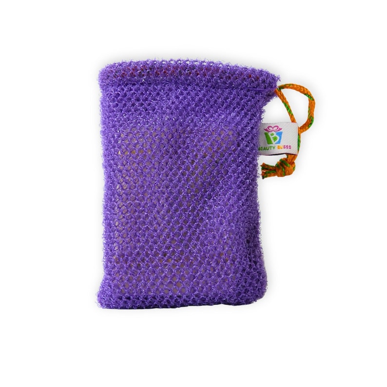May include: A purple mesh bag with a drawstring closure. The bag has a small tag with the text "BEAUTY BLISS" and a colorful logo. The drawstring is orange and green. The bag is likely used for bath products.