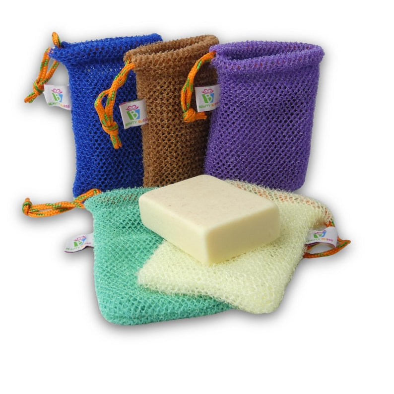 May include: A collection of colorful mesh soap saver bags in blue, brown, and purple, with a green and yellow mesh soap bag. A bar of soap rests on top of the green and yellow bags. Each bag has a drawstring closure.