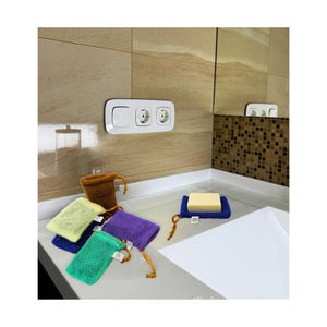 May include: A collection of colorful mesh soap bags in green, blue, yellow, purple, and brown, with a blue soap holder. The bags have drawstring closures and small tags. A bar of soap rests on a blue holder.