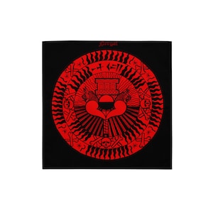 May include: Black square bandana with a red circular design. The design includes a central heart shape, a building, skulls, and the word "Pergal" at the top. The design is symmetrical and detailed.