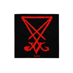 May include: Black square textile featuring a red sigil. The sigil is a stylized symbol with a triangle at the top and a cross-like shape below. The word "Lucifer" is printed in red at the bottom.