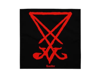 May include: Black square textile with a red sigil design. The sigil is a stylized symbol with a triangle at the top and a cross-like shape below. The word "Lucifer" is printed in red at the bottom.