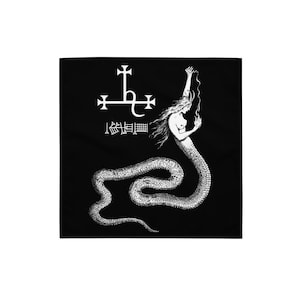 May include: Black square bandana with a white illustration of a woman with a snake tail, holding a flame. Above the figure are symbols and text. The design has a gothic and mystical theme. The bandana is likely made of a soft fabric.