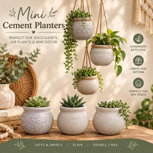 May include: A collection of six light gray cement planters, three hanging by jute ropes and three sitting on a wooden surface. The planters feature various textures including embossed dots, wavy lines, and plain smooth finishes, containing green succulents.