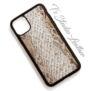 May include: A black phone case with a snakeskin pattern in shades of brown and white. The case has a raised camera lens cutout.