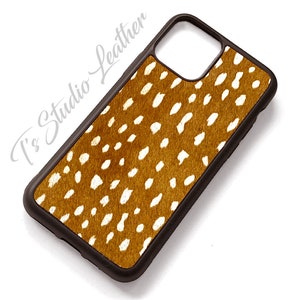 May include: A brown and white patterned phone case with a black border. The pattern resembles a deer's spots.