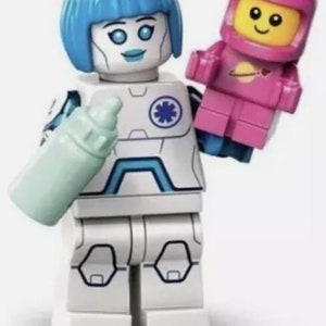 May include: A white and blue Lego minifigure with blue hair holding a light blue baby bottle and a pink Lego minifigure wearing a pink space suit.