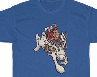 May include: A blue t-shirt with a cartoon illustration of a cowboy riding a white rabbit. The cowboy is wearing a red shirt, blue pants, and a cowboy hat. The rabbit is wearing a purple flower crown.